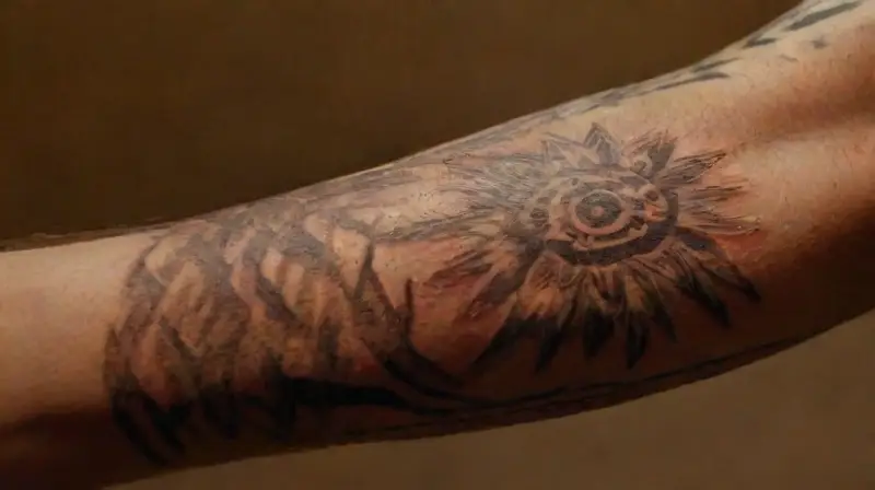 Close-up of tattooed, textured, weathered arm