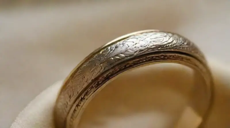 Close-up of detailed, shiny gold and platinum rings