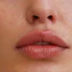 Close-up of lips with multiple piercings
