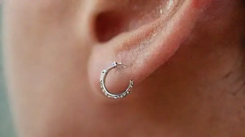 Close-up of pierced ear with eco jewelry