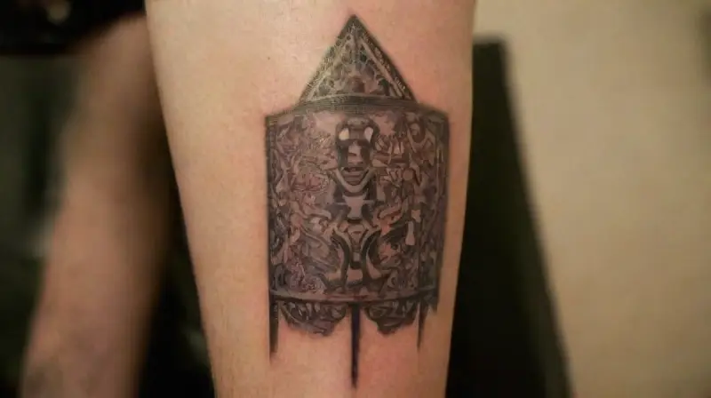 Professional tattoo artist creating detailed tribal ink