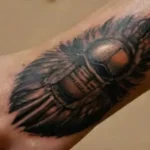 Close-up of detailed Egyptian tattooed forearm