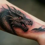 Forearm with scar and dragon tattoo