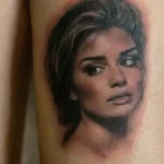 Realistic celebrity portrait tattoo on forearm