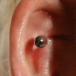 Close-up of a shiny earlobe piercing
