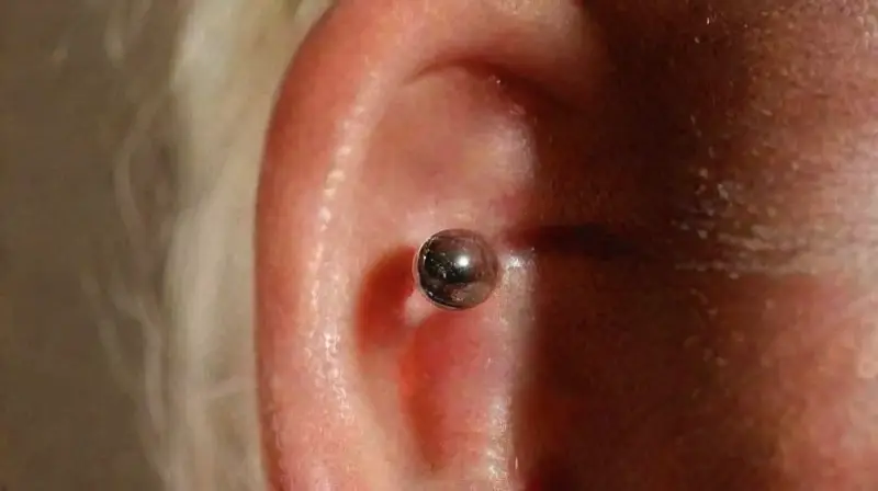 Close-up of a shiny earlobe piercing