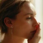 Person receives ear piercing in bright clinic