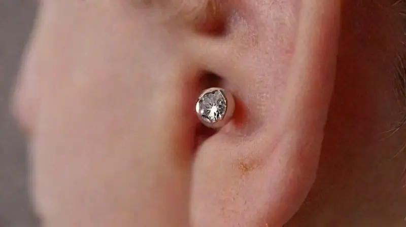 Close-up of pierced ear with detailed jewelry