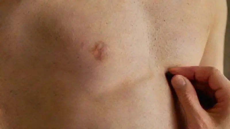 Artist draws precise anatomical lines on skin