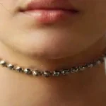 Close-up of pierced torso with detailed jewelry